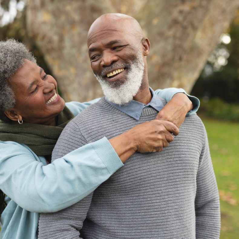 Image of happy african american senior couple posing at camera o